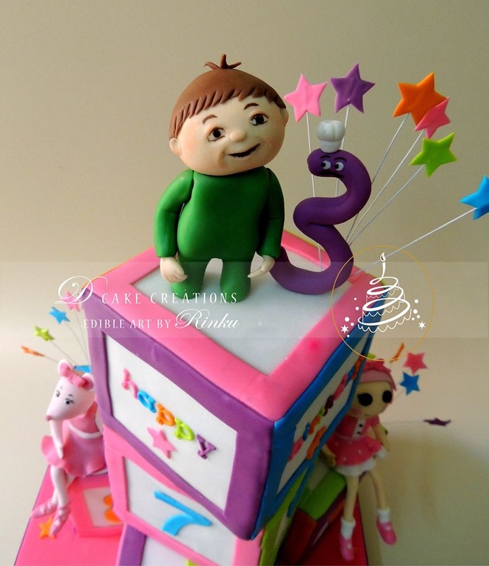  Charlie sits on Number Block Birthday Cake